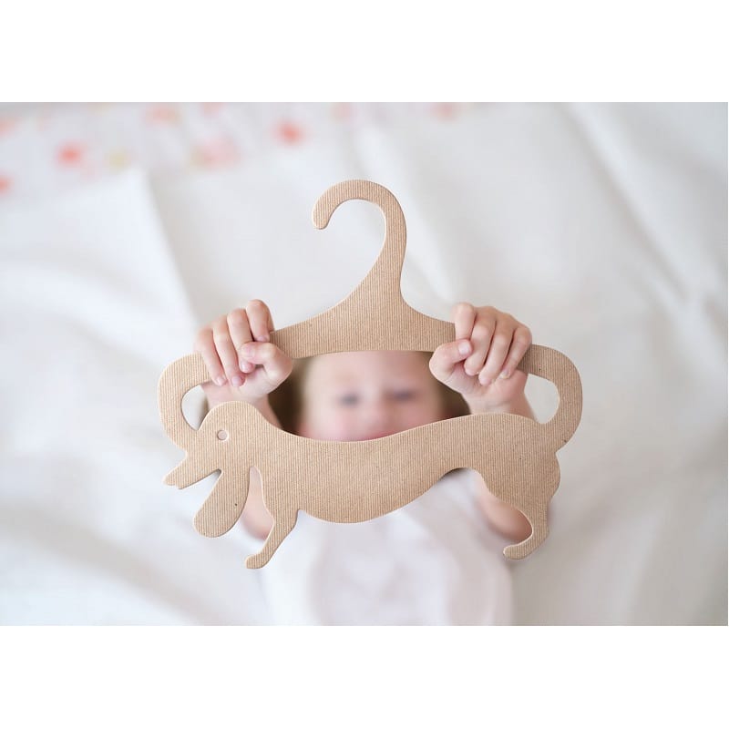 Child is holding wooden clothes hanger closeup