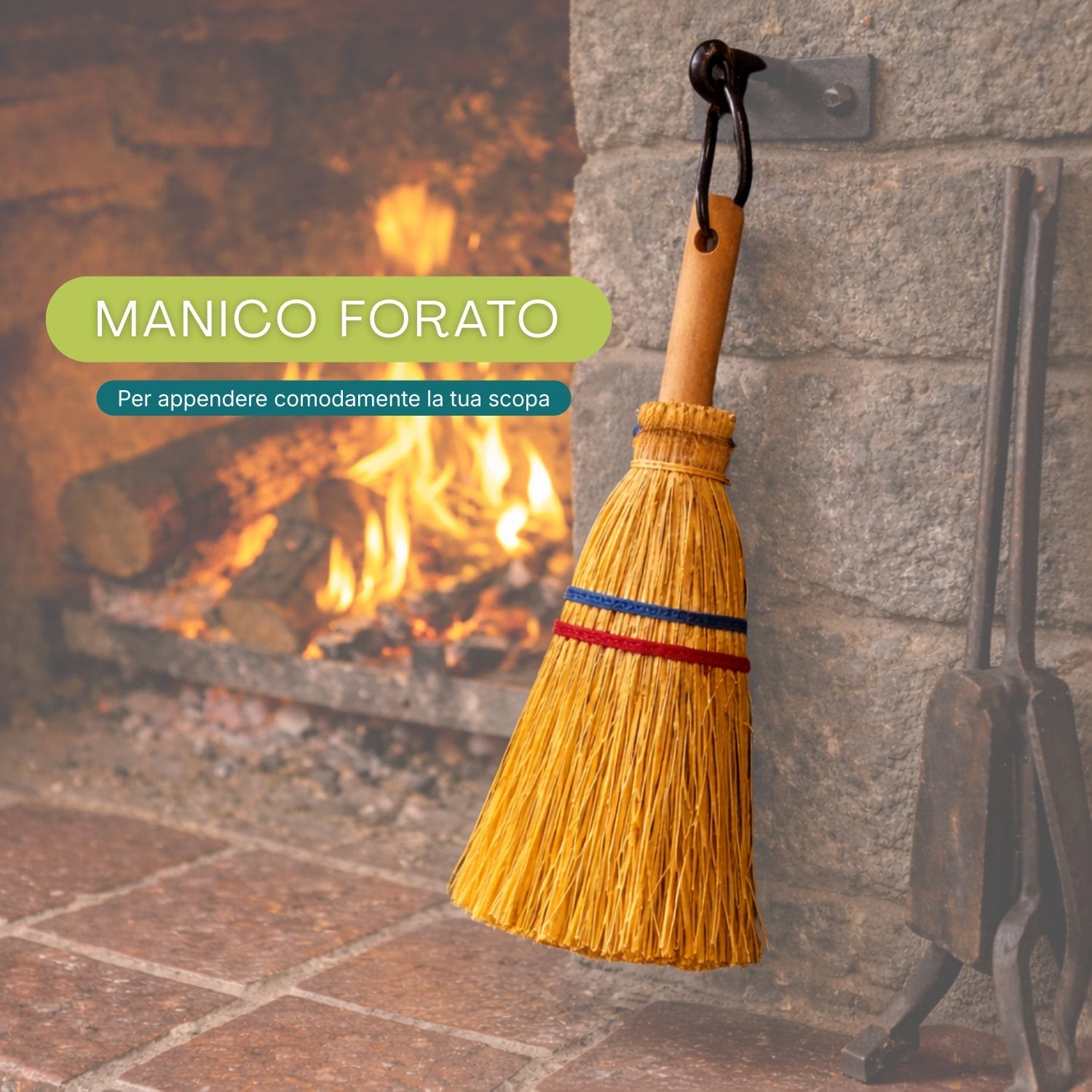 Scopa in saggina con manico forato appesa a un gancio vicino al camino